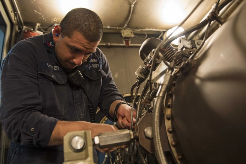 a man working on an object with a wrench