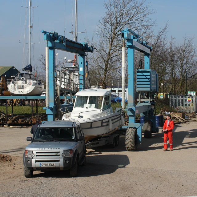 people stand near cars with a truck attached to it