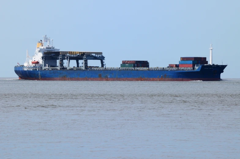 a large cargo ship sailing across the ocean