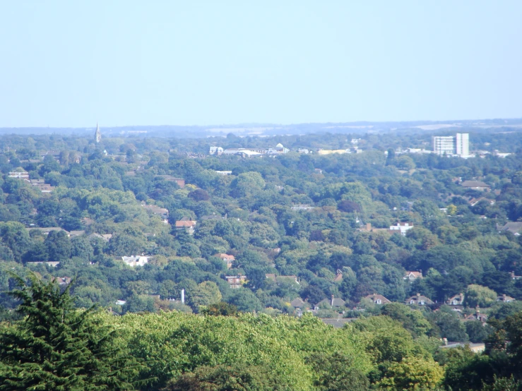 a po taken from the top of a hill looking at green hills and houses