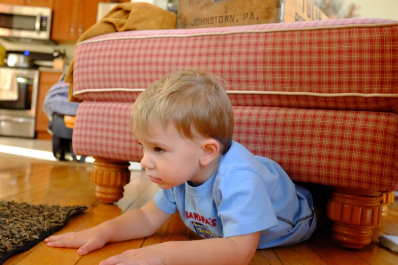 a  plays with a toy on the floor