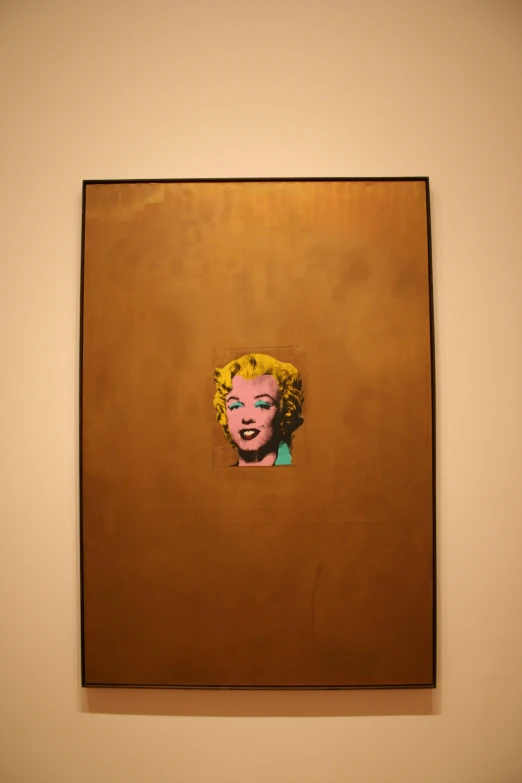 a painting of a woman wearing yellow lipstick is hanging on the wall