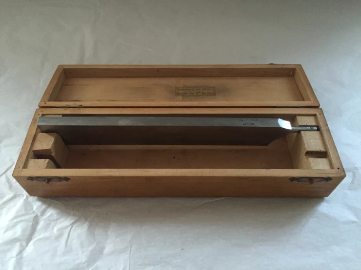 a knife set is in a wooden box