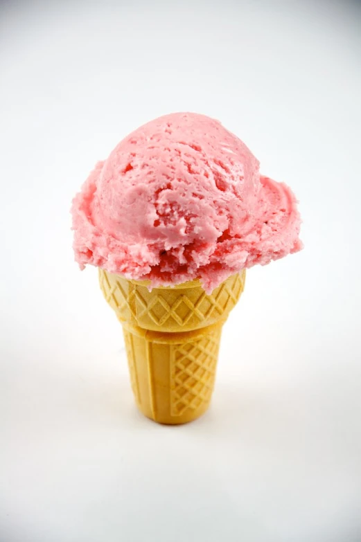 an ice cream cone has pink filling in it