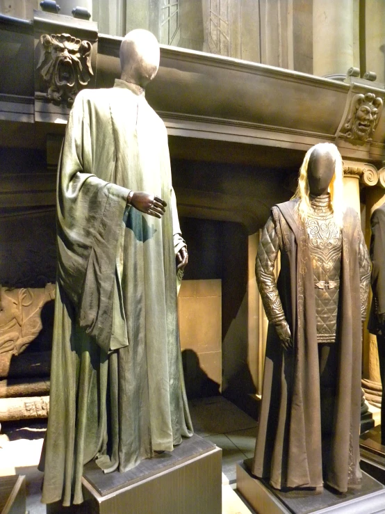 statues of men in clothes and accessories on display