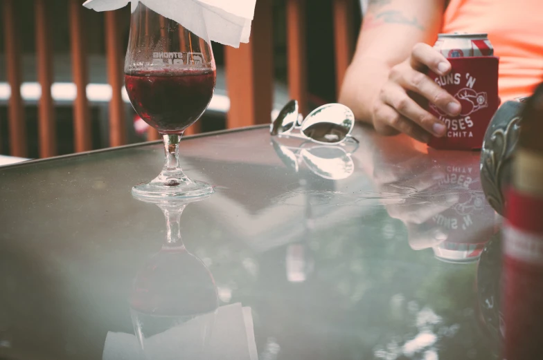 a table topped with a drink and covered with napkins