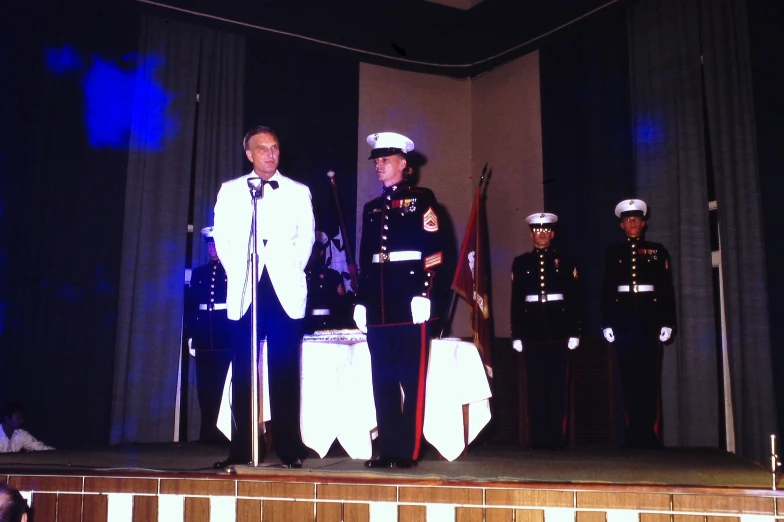 a group of people in military uniforms on stage