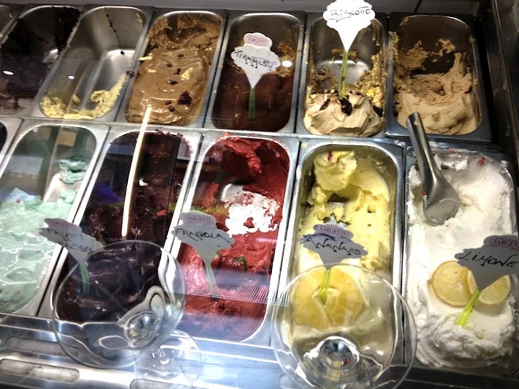 an ice cream parlor with trays of frozen treats