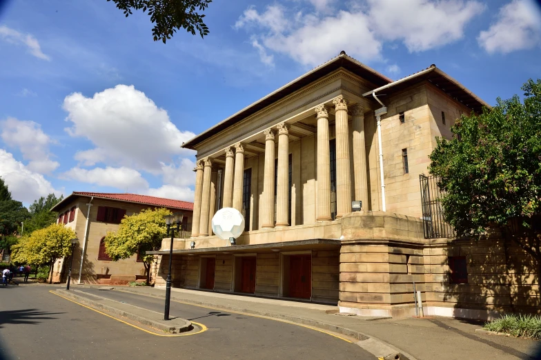 a tall building on a street with tall pillars