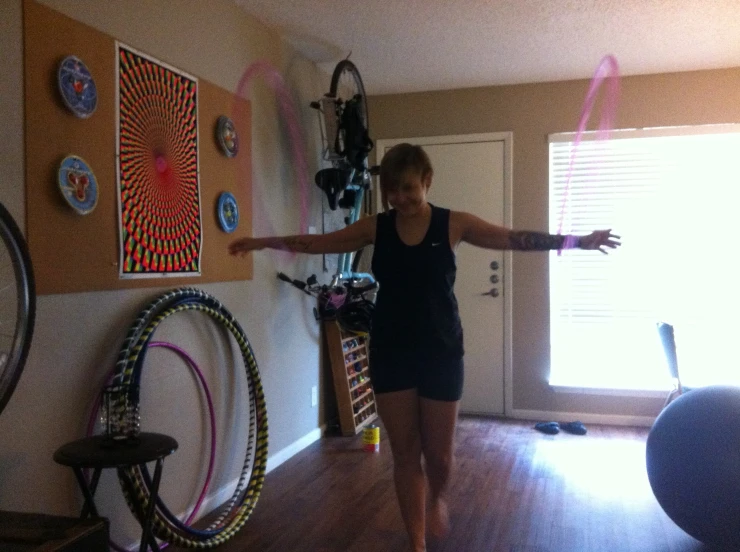 a woman walking through a living room next to a door