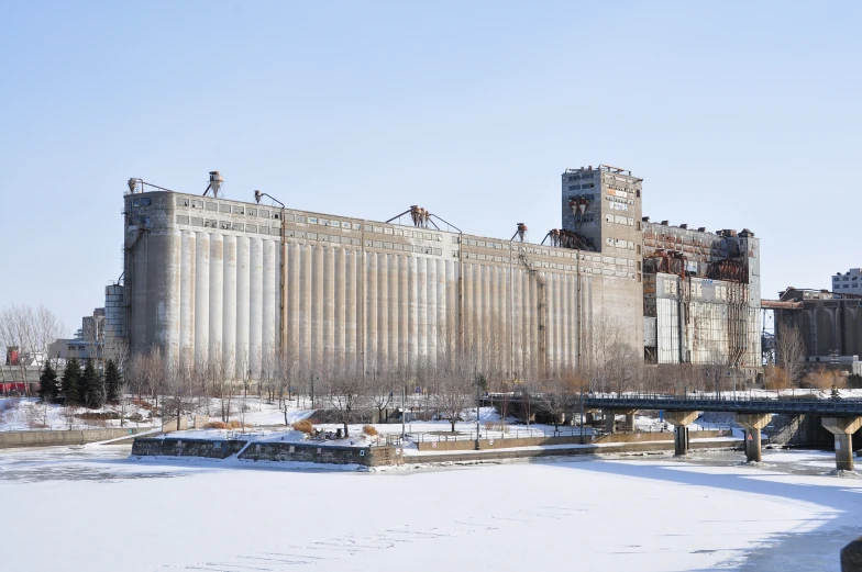 large building with a snow covered field in front