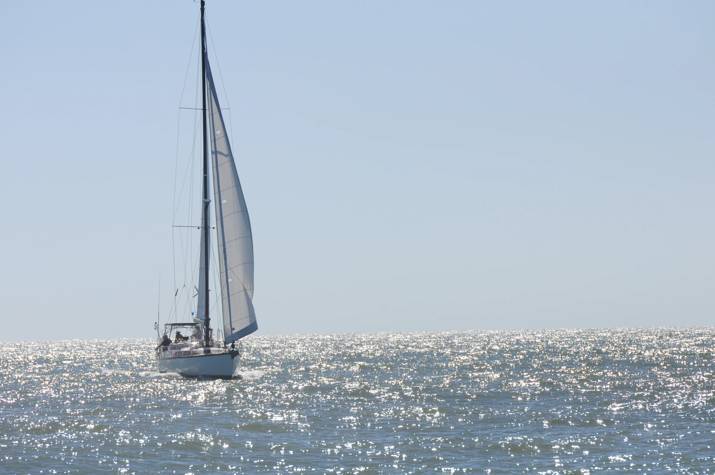 a large white sailboat in the middle of the ocean