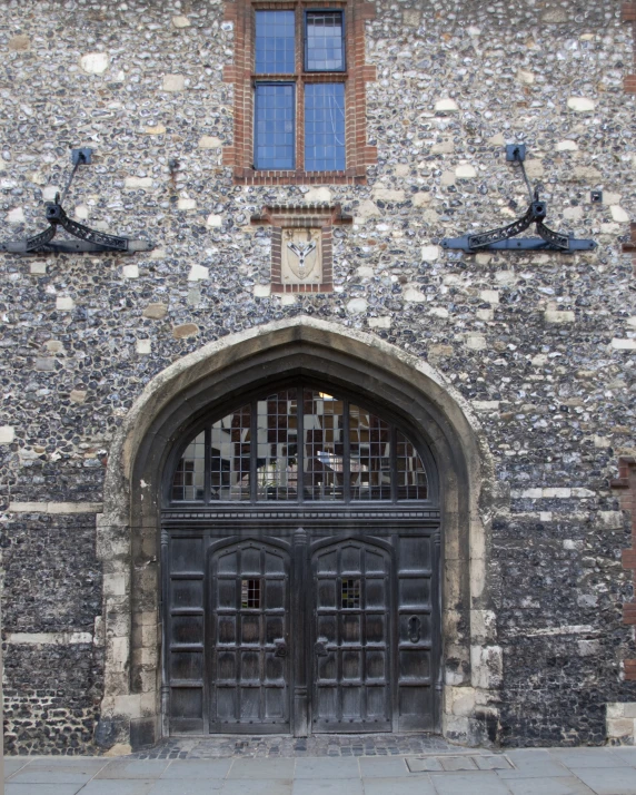 the black gate is open by the large black doors