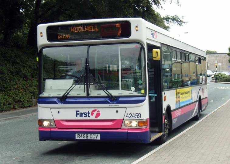 the large bus is parked on the side of the road