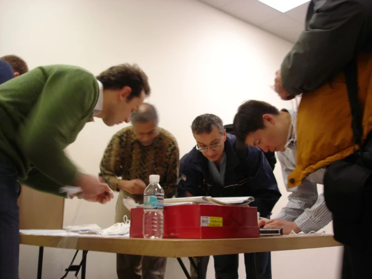 people in a room with a table filled with water