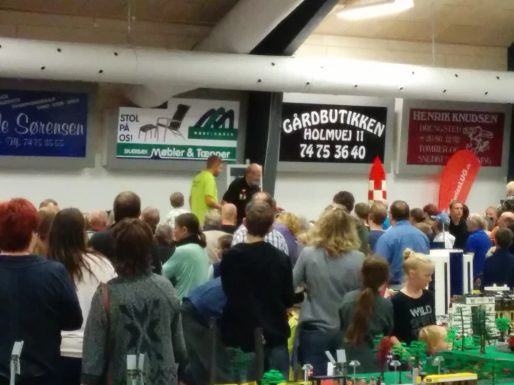 an indoor crowd of people in the convention