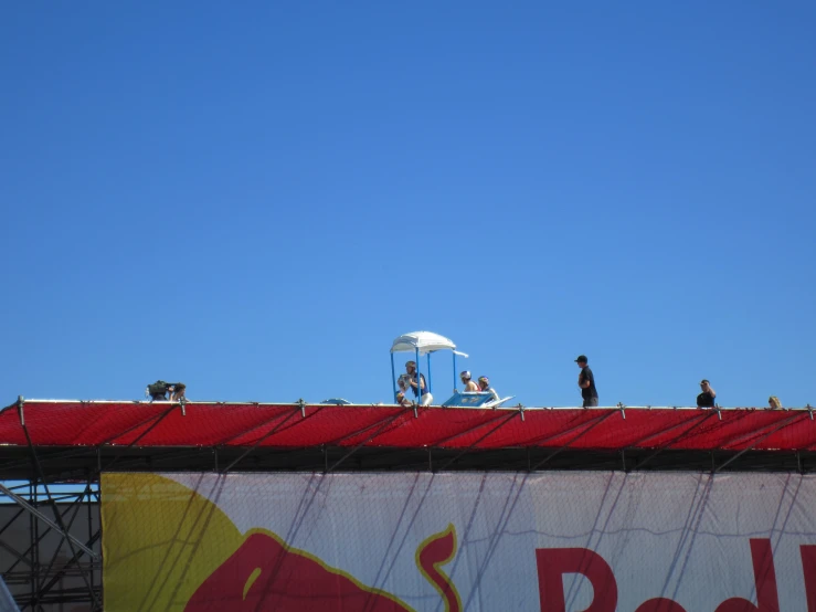 people standing on the roof of a building