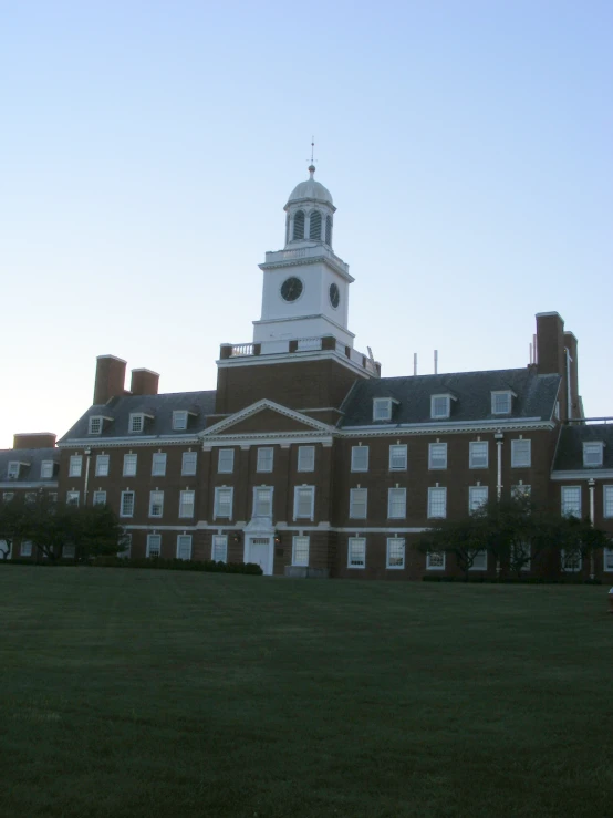 a large building with a clock tower in front