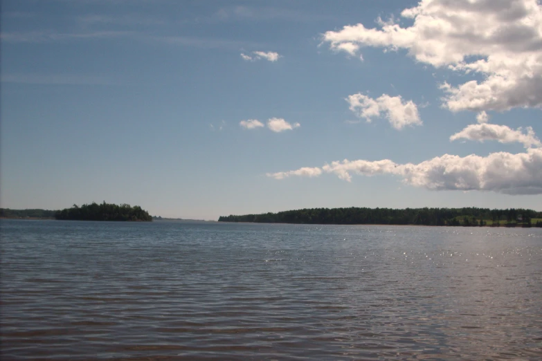 two island on the water and white clouds are above