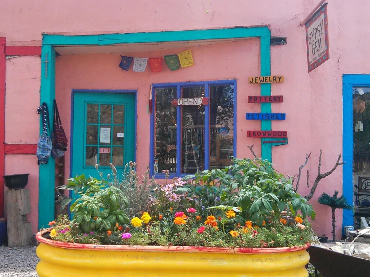 a planter of flowers in front of a colorful building