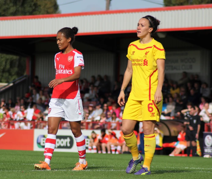 the girls are playing a game of soccer on the field