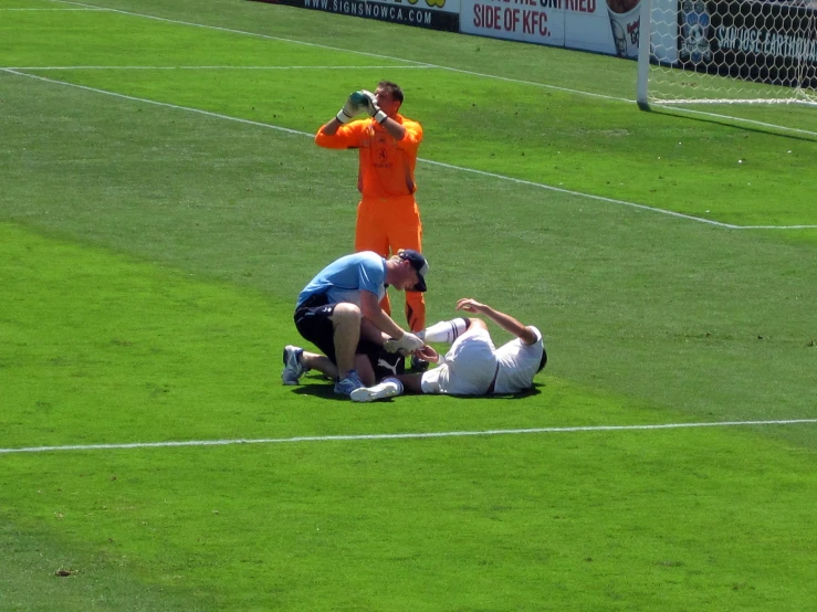 men with white balls in a field and a person reaching out