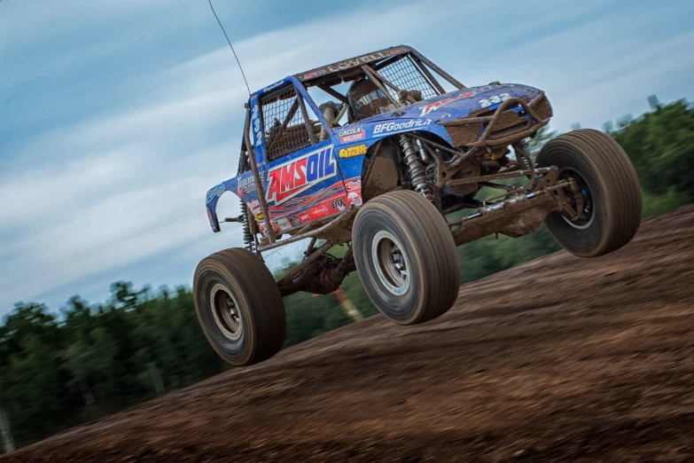 an extreme truck is jumping through the air on dirt