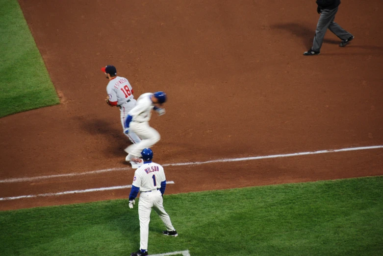 some baseball players standing on the field at the game