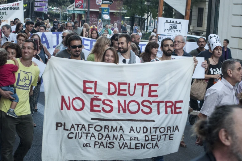 there are people marching in a rally on the street