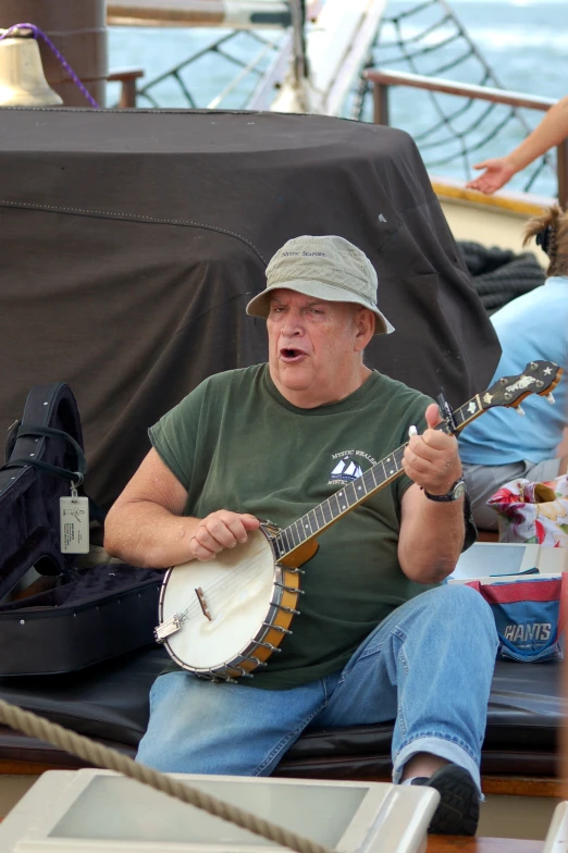 a man playing an instrument with other people on a boat