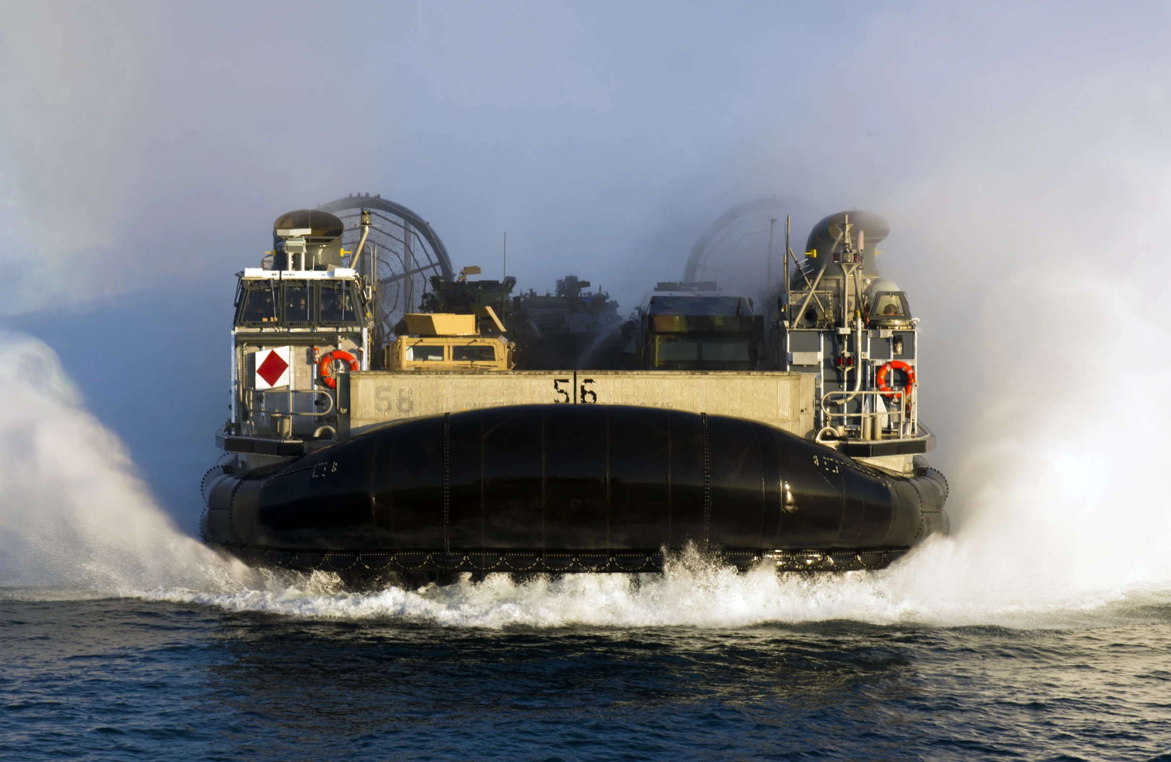 a large barge moving across the water near the shore