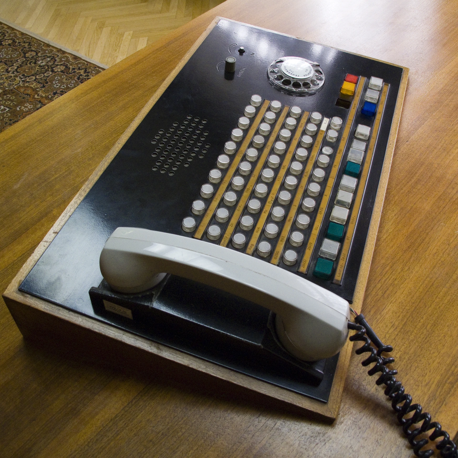 a very old telephone and a remote control