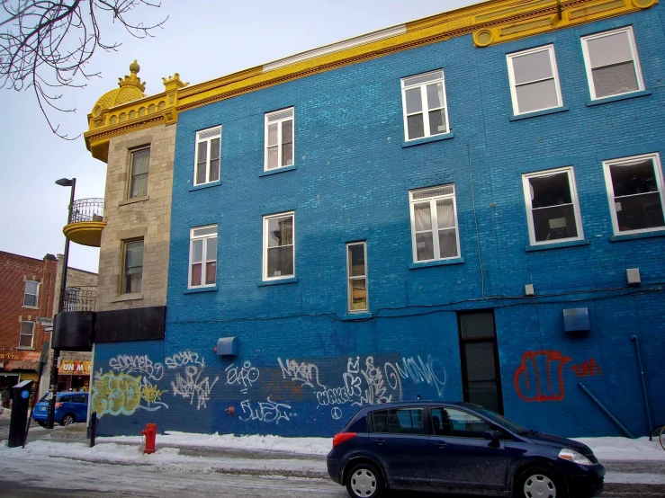 this is a blue building with yellow painted trim