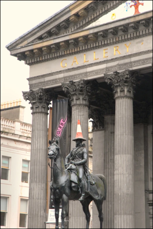 there is a statue with a man riding on top of it