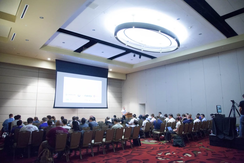 a large group of people in a room during a seminar