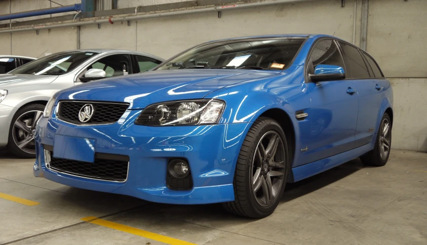 a couple of cars are parked in a parking garage