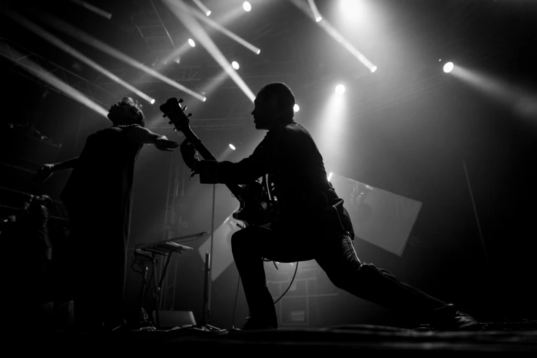 black and white po of an individual playing a guitar