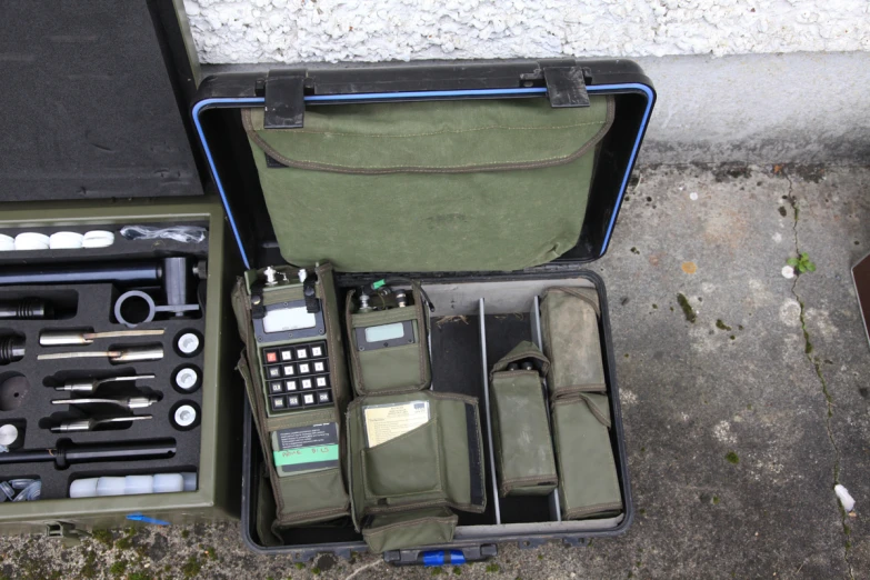 an open suitcase containing two electronic equipment