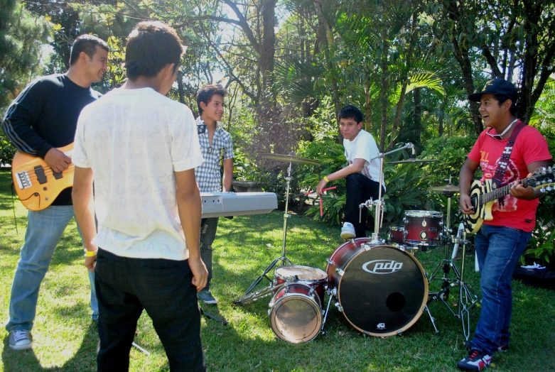 a group of men with guitars, drums and drums