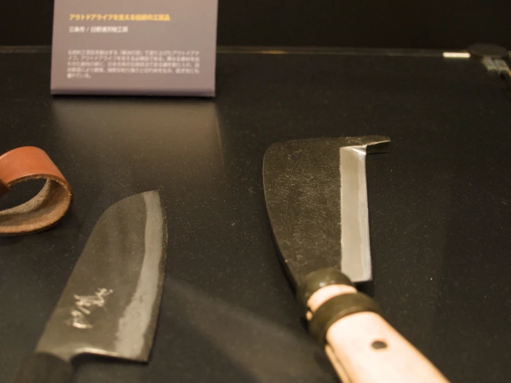 a knife and some brown tape on a table