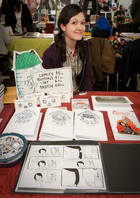 a woman sitting in front of a table filled with lots of greeting cards