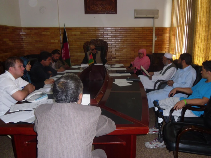 a group of people are sitting at the table