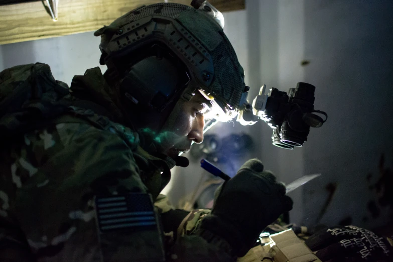 a man wearing gear while working on soing in a dark room