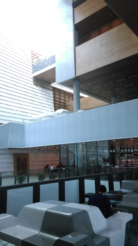 benches with a man sitting at a table inside a building