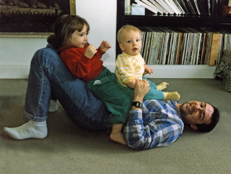 man holding a baby and posing for the camera