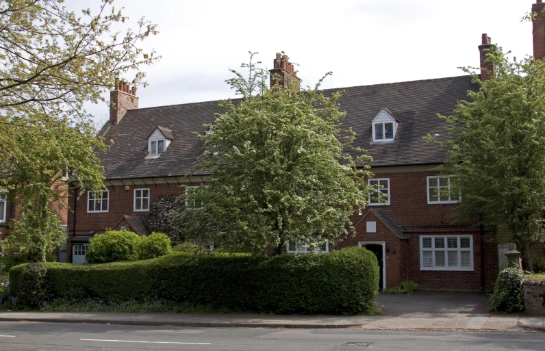 a brick building with a large front garden