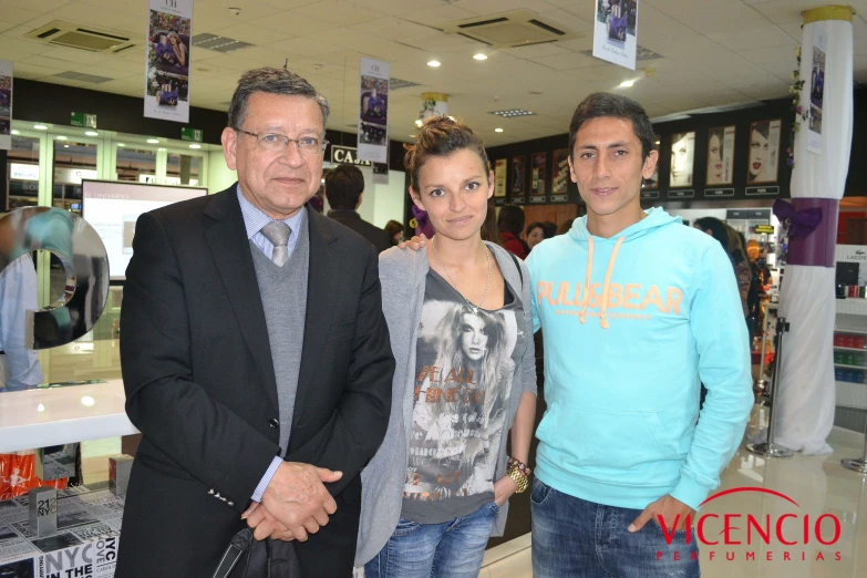 three people are posing for a picture inside a store