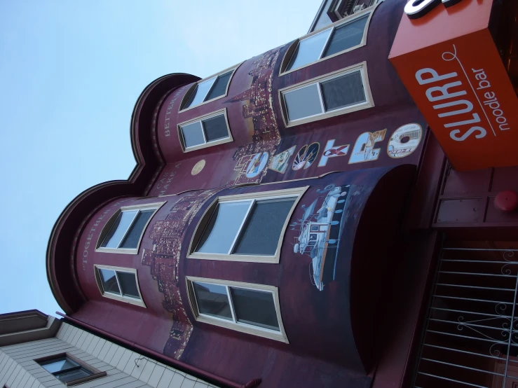 a red building with a big sign that says sushi