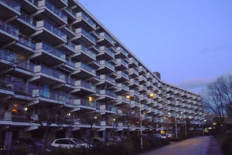 an apartment building and a walkway at dusk