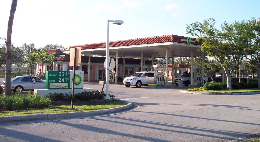 cars are parked at the gas station as it looks like it is empty